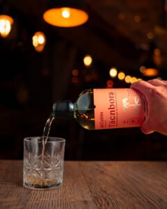 Whisky bottled being poured into a glass