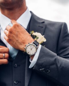 Watch on the groom's wrist, close up.