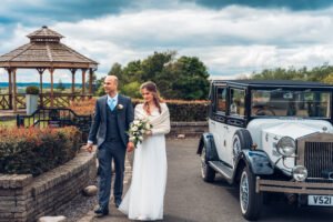 Groom and bride getting out of the car.