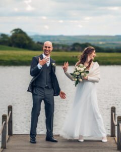 Bride and groom showing off their wedding rings.