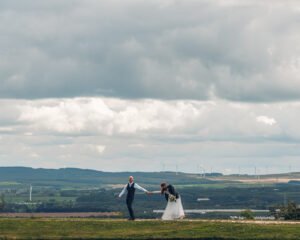 Groom pulls the bride in the distance.
