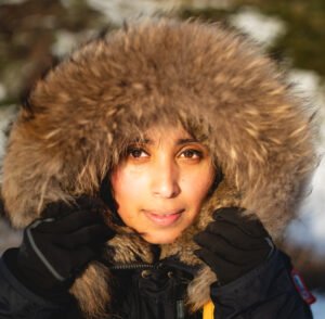 Young women holding her furry hoodie.