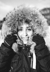 Young women holding her furry hoodie. Black and white.