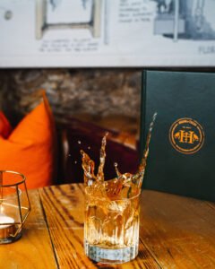 Ball of ice drop into an old fashioned.