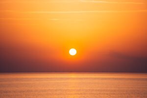 Sun setting over the sea in France.