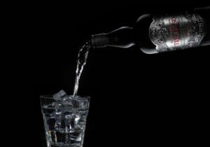 Bottle of gin being poured into a glass.