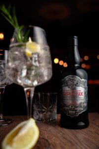 Bottle of triple six in the background, bokeh